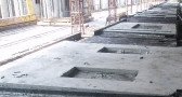 Casting beds carrying moulded panels with cast-in recesses